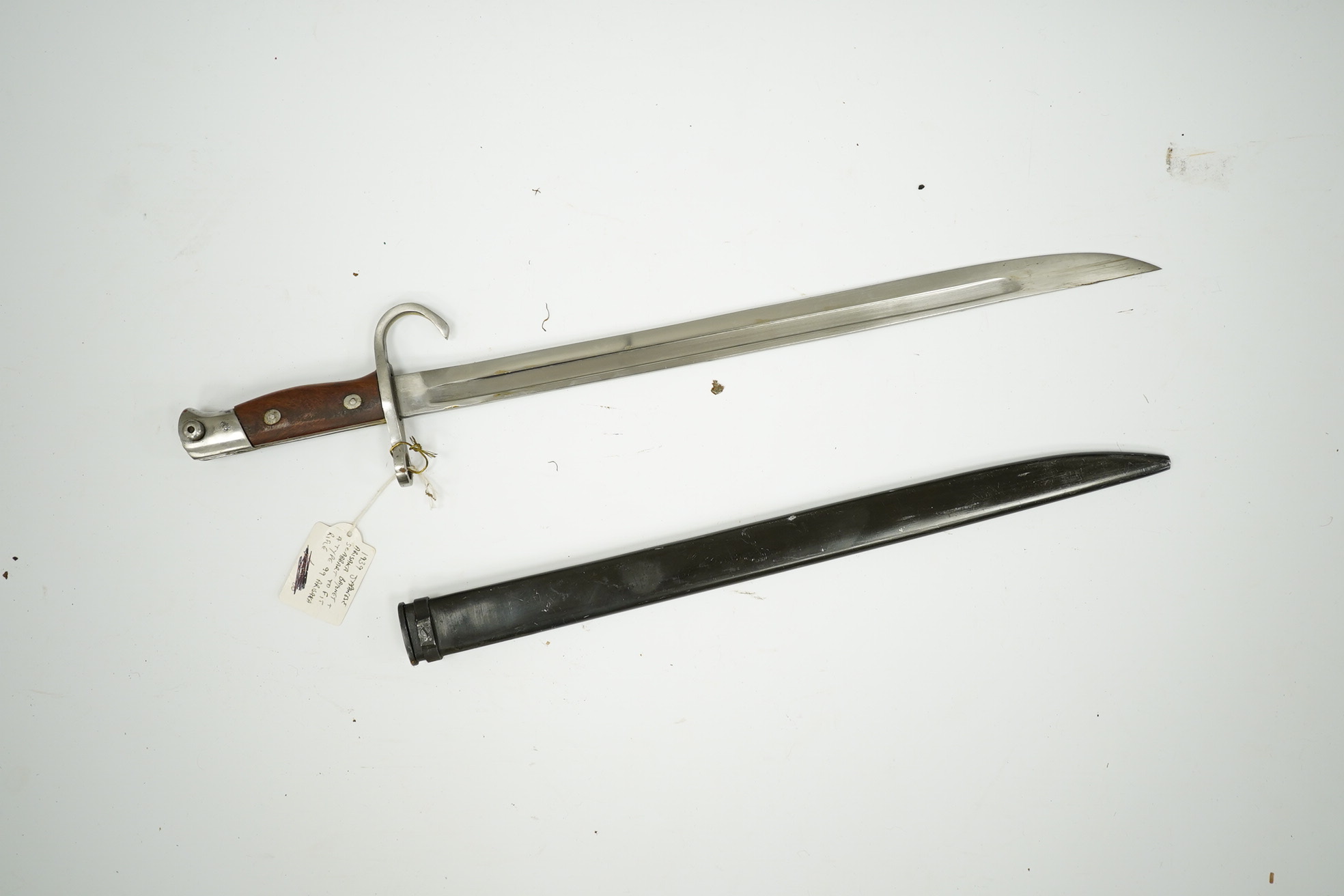 Three bayonets; a Japanese Arisaka bayonet, cleaned bright in its metal scabbard, a Nagant bayonet with quatrefoil blade, in good condition but missing scabbard, and a French Gras bayonet with the blade cut down. Conditi